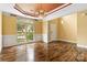 Bright dining room features hardwood flooring, elegant chandelier, large window with natural light, and neutral walls at 2346 Donnington Nw Ln, Concord, NC 28027