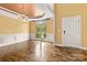 Sunlit dining area with hardwood floors, decorative ceiling, wainscoting, and a view of the front yard at 2346 Donnington Nw Ln, Concord, NC 28027