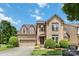 Charming two-story brick home featuring a manicured lawn, mature trees, and an attached two-car garage at 2346 Donnington Nw Ln, Concord, NC 28027