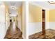 Hallway with hardwood floors leading to living room and kitchen showcasing abundant natural light and neutral walls at 2346 Donnington Nw Ln, Concord, NC 28027