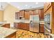 Modern kitchen featuring stainless steel appliances, gas cooktop, and granite countertops with ample storage at 2346 Donnington Nw Ln, Concord, NC 28027