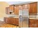 Spacious kitchen featuring stainless steel refrigerator, gas stovetop, ample cabinetry, and granite countertops at 2346 Donnington Nw Ln, Concord, NC 28027