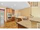 Kitchen featuring granite countertops, stainless steel appliances, wooden cabinets, and hardwood floors at 2346 Donnington Nw Ln, Concord, NC 28027
