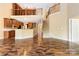Open-concept living room with hardwood floors, staircase, and kitchen view, offering a spacious and inviting atmosphere at 2346 Donnington Nw Ln, Concord, NC 28027