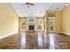 Spacious living room featuring a stone fireplace, hardwood floors, large windows, and plenty of natural light at 2346 Donnington Nw Ln, Concord, NC 28027