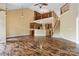 Open living space with hardwood floors, a staircase, and a view of the kitchen below a railed book nook at 2346 Donnington Nw Ln, Concord, NC 28027