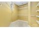 A walk-in closet with yellow walls and white wire shelving at 2346 Donnington Nw Ln, Concord, NC 28027