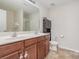 Bathroom featuring a double sink vanity with a large mirror at 2423 Dewey Creek Ln, Charlotte, NC 28216