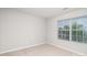Cozy bedroom with neutral walls, plush carpet, and a window at 2423 Dewey Creek Ln, Charlotte, NC 28216