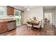 Bright dining area with wood floors, sliding glass doors, and modern lighting at 2423 Dewey Creek Ln, Charlotte, NC 28216
