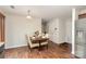 Open-concept dining area with wood floors and a view of the kitchen at 2423 Dewey Creek Ln, Charlotte, NC 28216
