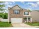 Charming two-story home with a brick and vinyl facade, complete with an attached garage and inviting front yard at 2423 Dewey Creek Ln, Charlotte, NC 28216