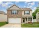 Charming two-story home with brick and vinyl siding and manicured front lawn at 2423 Dewey Creek Ln, Charlotte, NC 28216