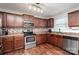 Well-appointed kitchen with stainless steel appliances, stylish backsplash, and wood floors at 2423 Dewey Creek Ln, Charlotte, NC 28216