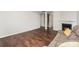 Open living room with fireplace, wood floors, and view of the stairs at 2423 Dewey Creek Ln, Charlotte, NC 28216