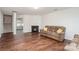 Inviting living room with a fireplace, staircase, and wood floors at 2423 Dewey Creek Ln, Charlotte, NC 28216