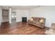 Spacious living room featuring a fireplace, staircase, and wood floors at 2423 Dewey Creek Ln, Charlotte, NC 28216