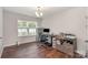 Bright office features hardwood floors, a window, a desk, and neutral walls at 2423 Dewey Creek Ln, Charlotte, NC 28216