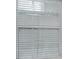 Close-up of a window with white blinds at 2423 Dewey Creek Ln, Charlotte, NC 28216