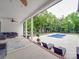 Expansive back patio features a seating area, swimming pool, and lush landscaping for outdoor enjoyment at 2608 Henry Baucom Rd, Monroe, NC 28110