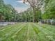 Expansive backyard with meticulously striped lawn, bordered by mature trees at 2608 Henry Baucom Rd, Monroe, NC 28110