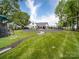 Expansive backyard featuring a playground, lush lawn, professional landscaping and privacy fence at 2608 Henry Baucom Rd, Monroe, NC 28110