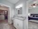 Stylish bathroom with a granite countertop vanity, light gray walls, and an open door to a bedroom at 2608 Henry Baucom Rd, Monroe, NC 28110