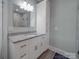 Bright bathroom with granite countertops, a storage cabinet, a large mirror, and light gray walls at 2608 Henry Baucom Rd, Monroe, NC 28110