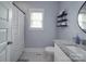 Bathroom has granite sink, white tile floors, and new white shower curtain at 2608 Henry Baucom Rd, Monroe, NC 28110