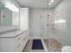 Modern bathroom featuring granite countertops, a glass door shower, and light gray walls at 2608 Henry Baucom Rd, Monroe, NC 28110