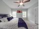 Comfortable bedroom featuring a large bed, ceiling fan, windows, and light gray walls at 2608 Henry Baucom Rd, Monroe, NC 28110