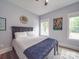 Cozy bedroom featuring hardwood floors, light gray walls, and two windows providing ample natural light at 2608 Henry Baucom Rd, Monroe, NC 28110