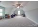Spacious bonus room with plush carpeting, neutral paint, storage and ceiling fan at 2608 Henry Baucom Rd, Monroe, NC 28110