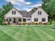 Charming traditional home with a manicured lawn and a welcoming front porch at 2608 Henry Baucom Rd, Monroe, NC 28110