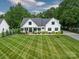 Charming traditional home with a manicured lawn and a welcoming front porch at 2608 Henry Baucom Rd, Monroe, NC 28110