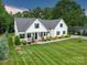 Charming traditional home with a manicured lawn and a welcoming front porch at 2608 Henry Baucom Rd, Monroe, NC 28110