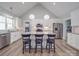 Modern kitchen features an island with bar seating, stainless appliances, and wood floors at 2608 Henry Baucom Rd, Monroe, NC 28110