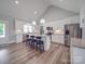Eat-in kitchen boasts white cabinets, stainless steel appliances, and granite countertops at 2608 Henry Baucom Rd, Monroe, NC 28110