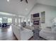 Open concept living room with stone fireplace, lots of natural light, and hardwood floors at 2608 Henry Baucom Rd, Monroe, NC 28110