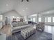 Open concept living room with view into kitchen, hardwood floors, and lots of natural light at 2608 Henry Baucom Rd, Monroe, NC 28110