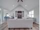 Bright living room features a stone fireplace, vaulted ceiling, and hardwood floors at 2608 Henry Baucom Rd, Monroe, NC 28110