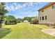Sprawling backyard with a well-maintained lawn, mature trees, and house views perfect for outdoor activities at 261 Melrose Sw Dr, Concord, NC 28025