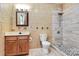 Bathroom featuring a tiled shower with rainfall showerhead, a new vanity with white sink and bronze faucet at 261 Melrose Sw Dr, Concord, NC 28025