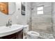 Modern bathroom featuring a tiled shower with rainfall showerhead, a new vanity with white sink and chrome faucet at 261 Melrose Sw Dr, Concord, NC 28025