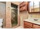 Ceramic-tiled bathroom featuring a glass-enclosed shower and wood vanity for a warm, inviting space at 261 Melrose Sw Dr, Concord, NC 28025