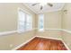Cozy bedroom features hardwood floors, neutral walls, and a ceiling fan providing comfort at 261 Melrose Sw Dr, Concord, NC 28025