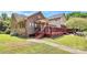 Exterior view of the house from the backyard, featuring the deck and lush green grass at 261 Melrose Sw Dr, Concord, NC 28025