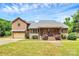 Charming brick home with a welcoming front porch and well-maintained landscaping under a partly cloudy sky at 261 Melrose Sw Dr, Concord, NC 28025