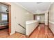 A bright hallway with wood floors, with view into a bedroom, and with stairs leading to another level at 261 Melrose Sw Dr, Concord, NC 28025