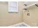 Functional laundry area with shelves for storage and a convenient spot for laundry tasks at 261 Melrose Sw Dr, Concord, NC 28025